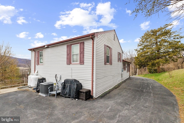 view of property exterior with central AC