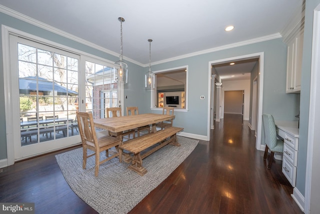 dining area with baseboards, ornamental molding, dark wood-type flooring, and built in study area