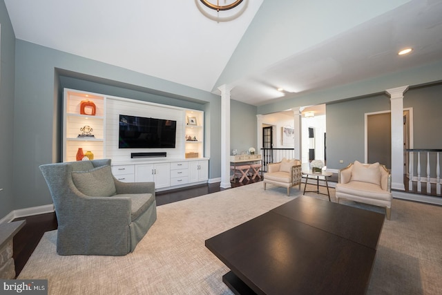 living area with lofted ceiling, ornate columns, baseboards, and recessed lighting