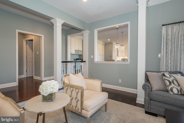 living room with ornate columns, baseboards, dark wood finished floors, and recessed lighting