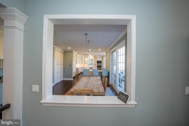 dining area with dark wood-style floors, recessed lighting, ornamental molding, and ornate columns