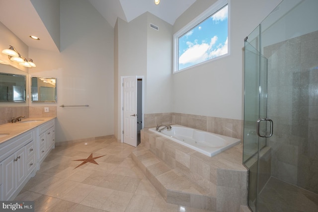 bathroom featuring double vanity, a stall shower, visible vents, a garden tub, and a sink