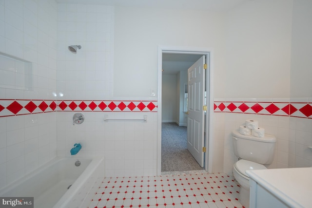 bathroom with toilet, a bathing tub, a wainscoted wall, vanity, and tile walls