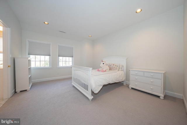 bedroom with carpet floors, recessed lighting, visible vents, and baseboards