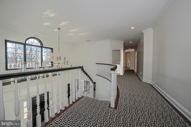 hall with baseboards, ornamental molding, dark colored carpet, an upstairs landing, and recessed lighting