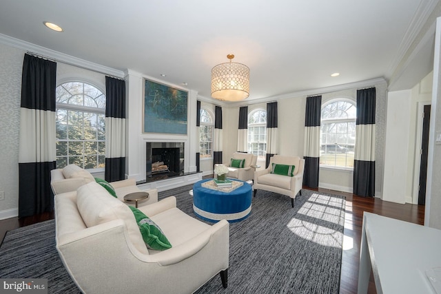 living room with crown molding, recessed lighting, a fireplace with raised hearth, wood finished floors, and baseboards