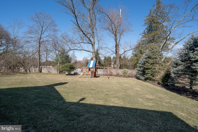 view of yard featuring a playground and fence