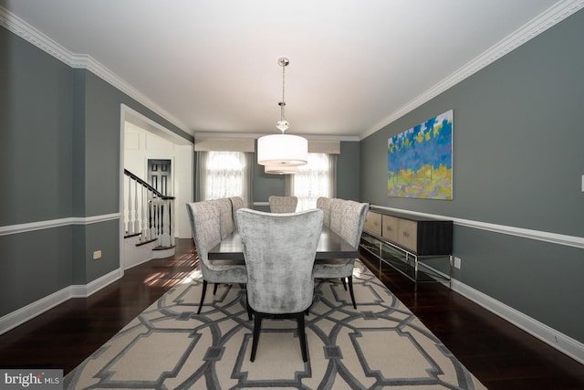 dining space featuring crown molding, stairs, baseboards, and wood finished floors