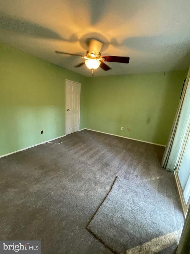 unfurnished bedroom with ceiling fan, a textured ceiling, and carpet flooring