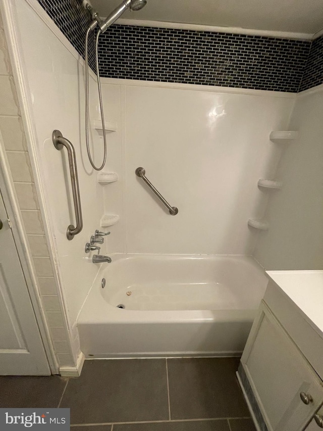 bathroom featuring tile patterned flooring, tub / shower combination, and vanity