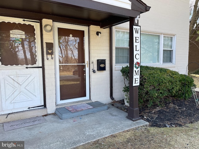 property entrance featuring concrete block siding