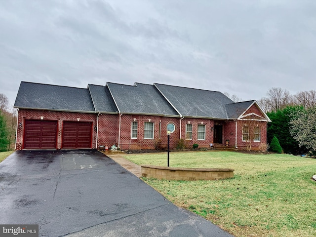 view of front facade featuring brick siding, driveway, a front yard, and a garage