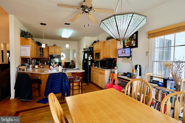 dining room with light wood-style floors and a ceiling fan