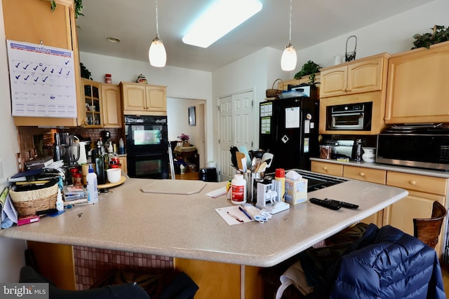 kitchen featuring black appliances, a breakfast bar, light brown cabinets, and light countertops