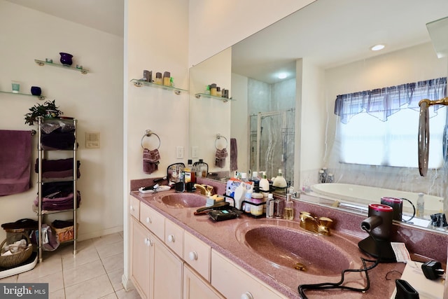 bathroom featuring a sink, a garden tub, a stall shower, and tile patterned floors