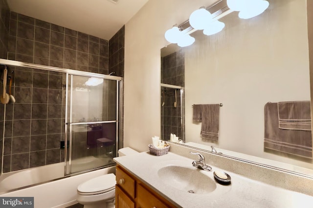 bathroom with enclosed tub / shower combo, toilet, and vanity