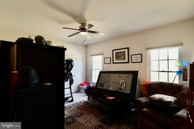 interior space featuring a ceiling fan and carpet floors