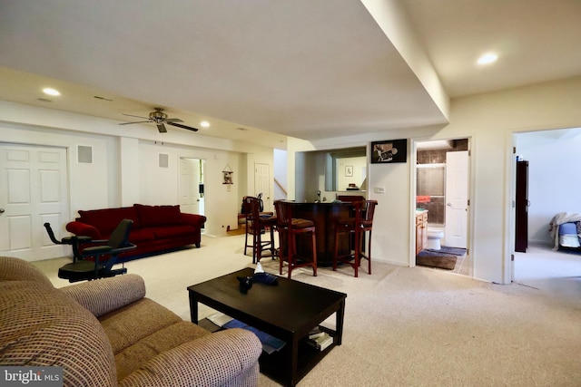 living room featuring recessed lighting, a dry bar, and carpet