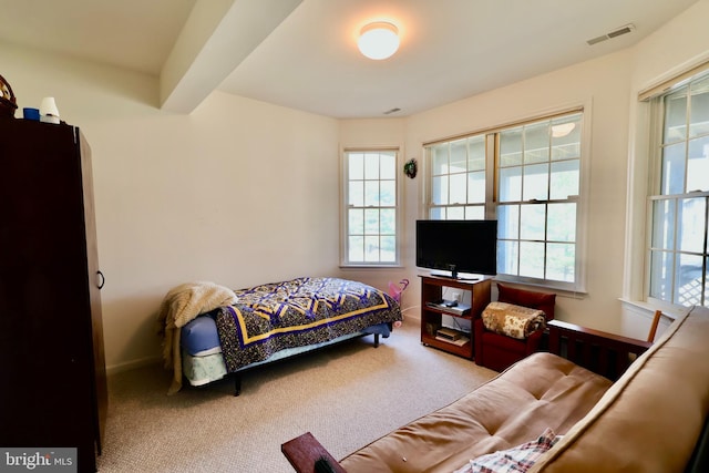 carpeted bedroom featuring visible vents and baseboards