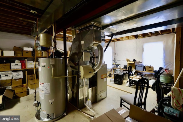 utility room featuring gas water heater and heating unit