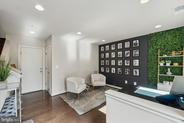 living area with recessed lighting, visible vents, baseboards, and dark wood finished floors