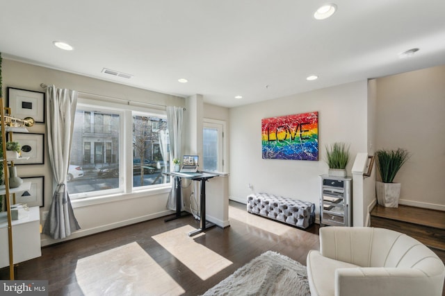 living area with recessed lighting, wood finished floors, visible vents, and baseboards