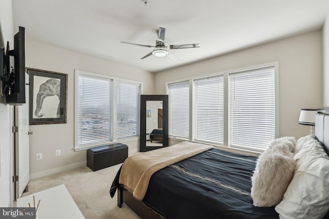 carpeted bedroom featuring ceiling fan and baseboards