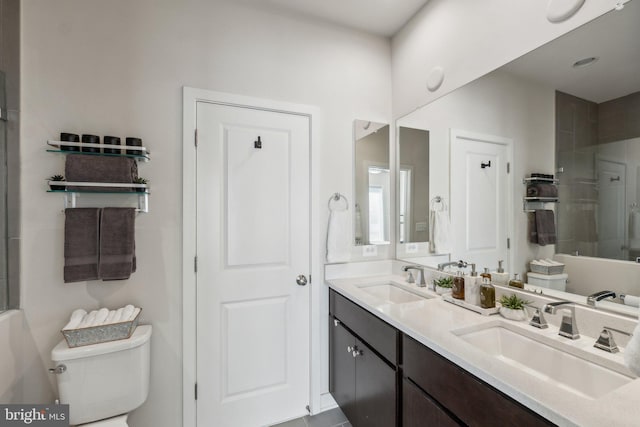 bathroom with a sink, toilet, and walk in shower