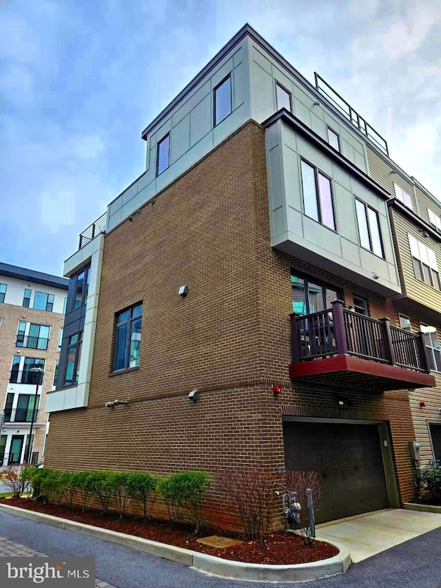 view of property with aphalt driveway and an attached garage