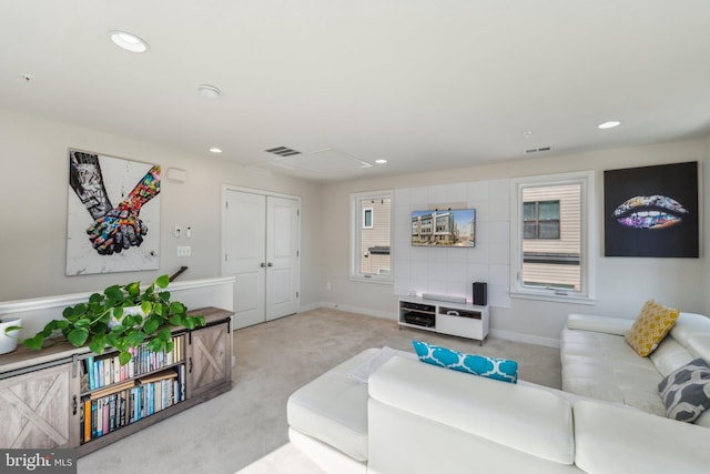 carpeted living room with recessed lighting, visible vents, and baseboards