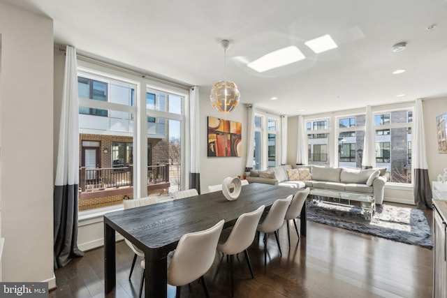 dining area featuring dark wood-type flooring, recessed lighting, and a healthy amount of sunlight