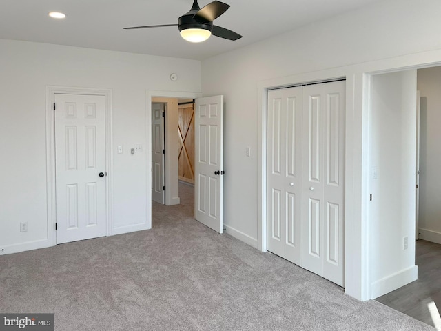 unfurnished bedroom featuring a ceiling fan, baseboards, a closet, and carpet flooring