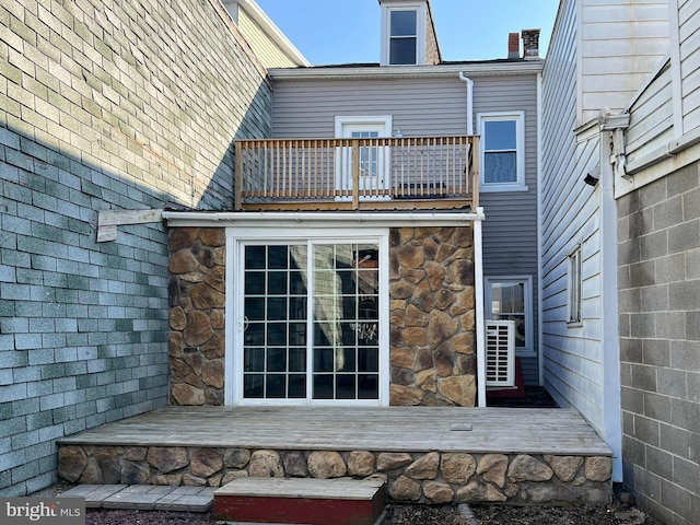 rear view of property featuring a balcony