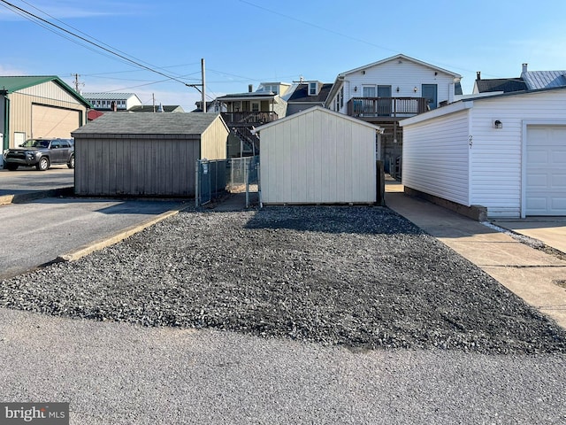 exterior space with fence and a storage unit