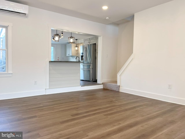 interior space with baseboards, stairway, dark wood-style flooring, a wall mounted AC, and recessed lighting