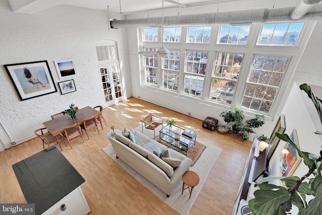 interior space with a towering ceiling and wood finished floors