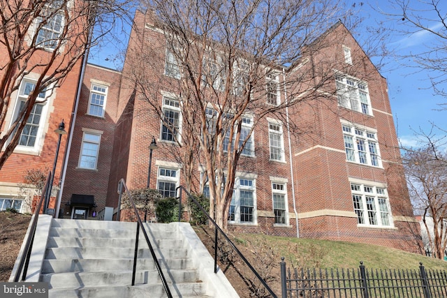 view of building exterior featuring a fenced front yard