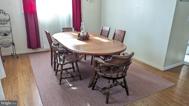 dining room featuring baseboards and wood finished floors