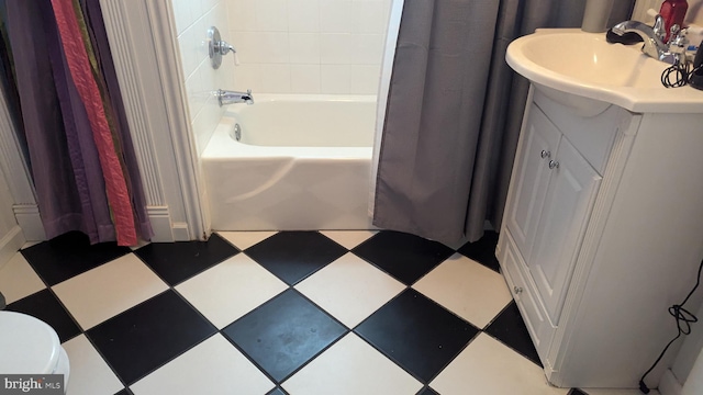 bathroom with tile patterned floors, vanity, and shower / bathtub combination with curtain