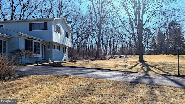 view of yard with aphalt driveway