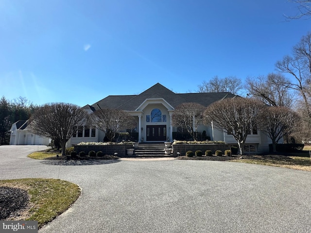 view of front of property with french doors and curved driveway