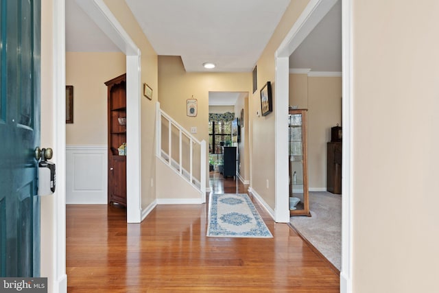 entryway with stairway, wood finished floors, and baseboards