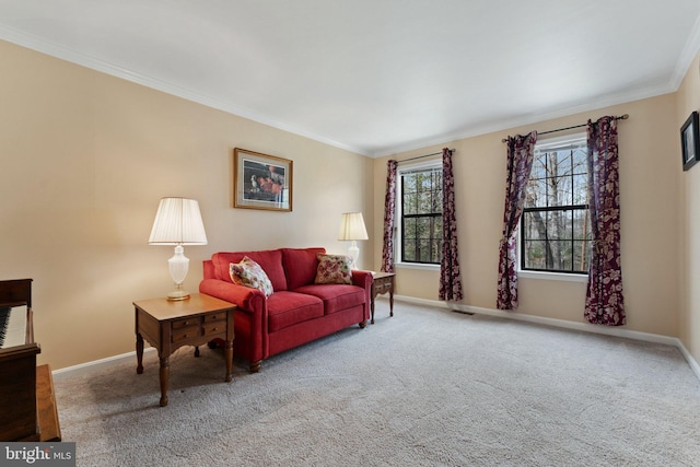 living area with baseboards, crown molding, and carpet flooring