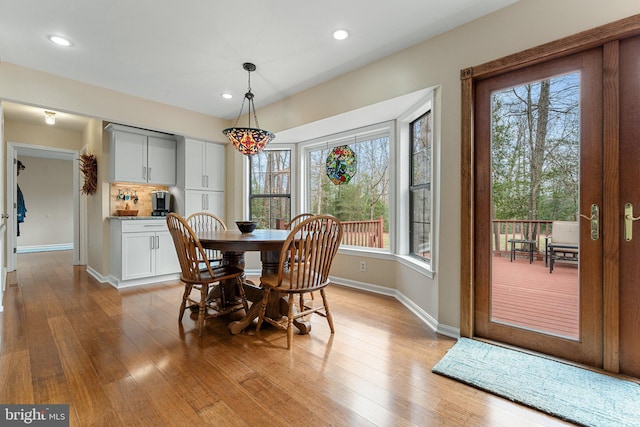 dining area with baseboards, recessed lighting, and light wood-style floors