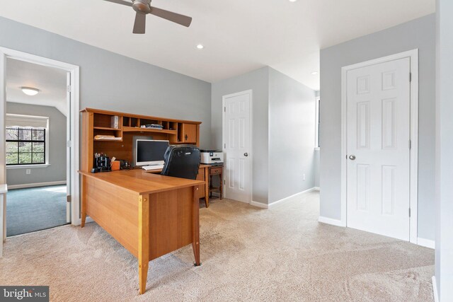 office area with light carpet, baseboards, and a ceiling fan