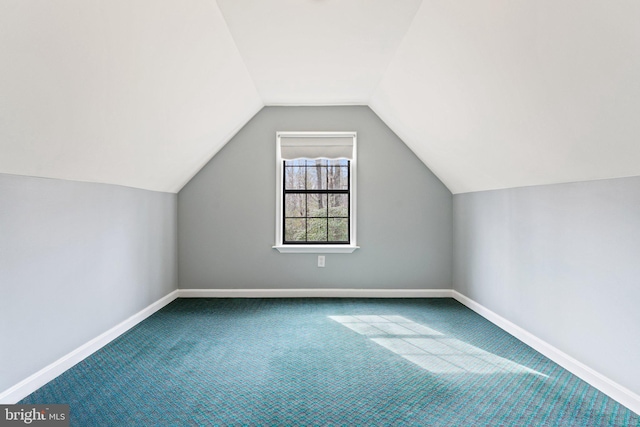 additional living space with carpet floors, baseboards, and lofted ceiling