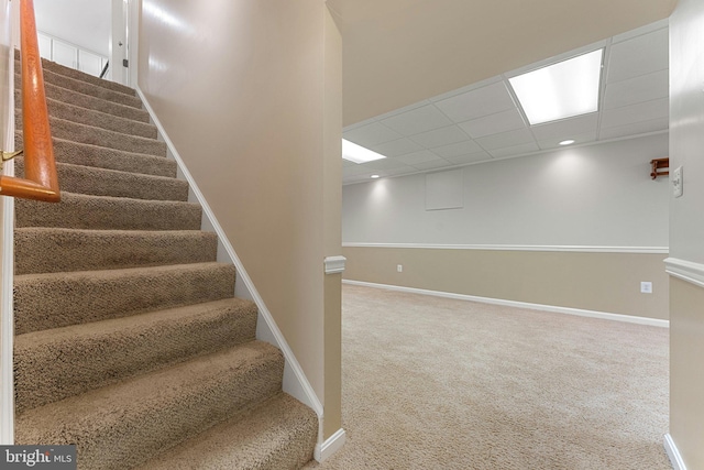 staircase with carpet, a drop ceiling, baseboards, and recessed lighting