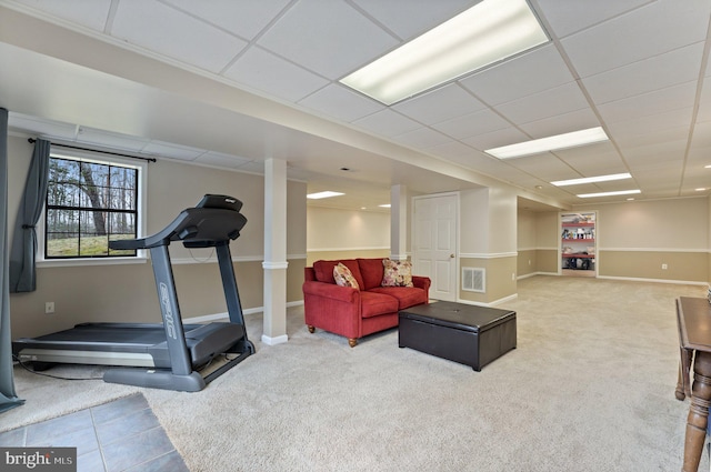 exercise room featuring baseboards, carpet, visible vents, and a drop ceiling