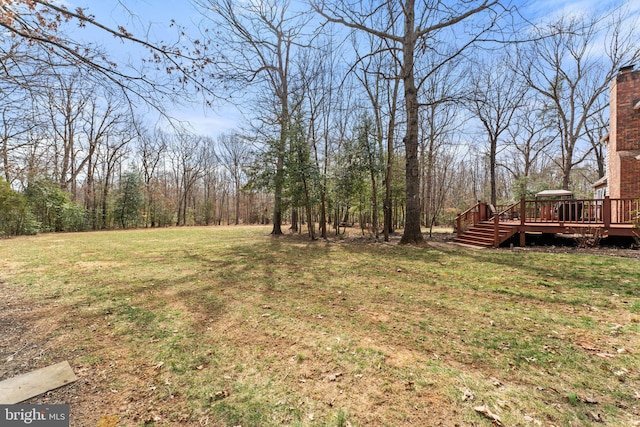 view of yard featuring a wooden deck