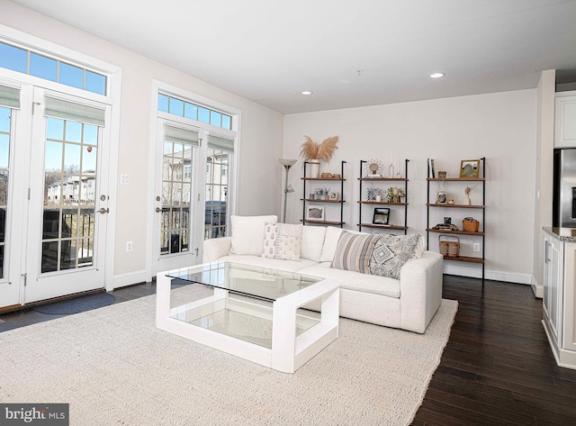 living room with dark wood-style floors, baseboards, and recessed lighting